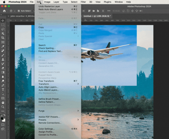 Using the auto blend layers tool in photoshop to add a photo of an airplane flying through a clear blue sky, to an image of a mountains with trees and a lake