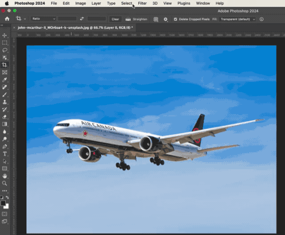 Using the Select subject tool in photoshop to select the airplane in a photo of an airplane flying through a clear blue sky