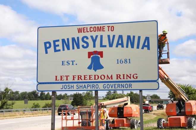 The New Pennsylvania State Welcome Sign to Celebrate America's 250th Anniversary - and off white billboard with "Pennsylvania Let Freedom Ring" and a liberty bell in the background